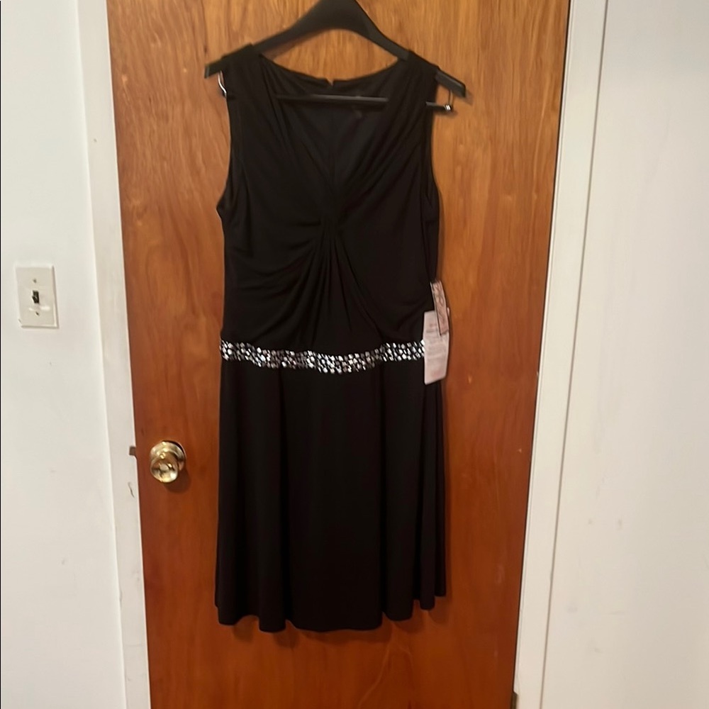 Elegant Black Embellished Dress. Size 12. Below the knee.New with tag.